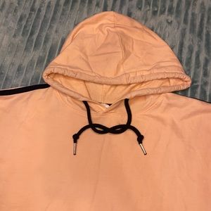 Peach colored cropped sleeveless hoodie